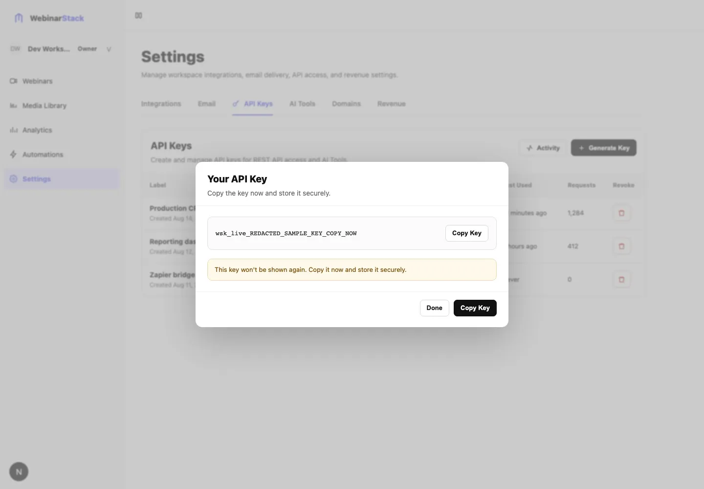 Your API Key dialog showing a redacted sample key, Copy Key action, and the warning that the key will not be shown again